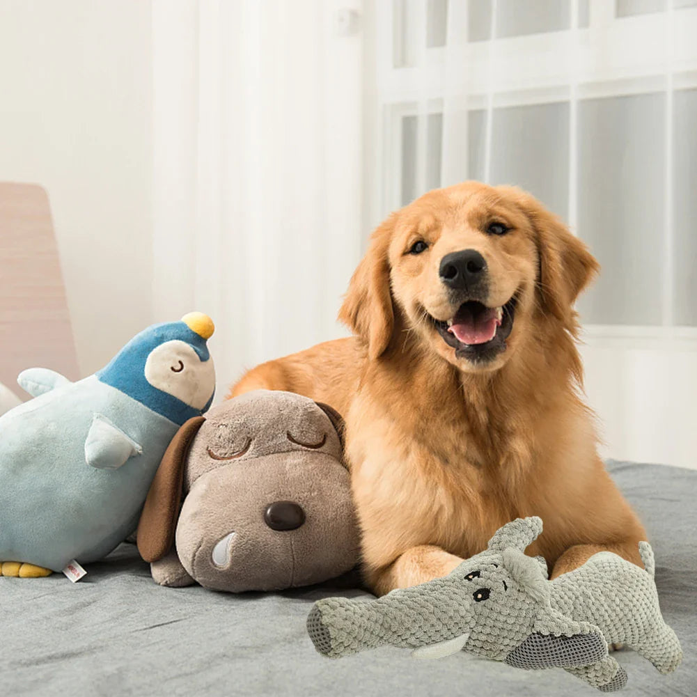 A cat and a dog eat treats near a green interactive pet food dispenser with a spinning wheel design on a white background.