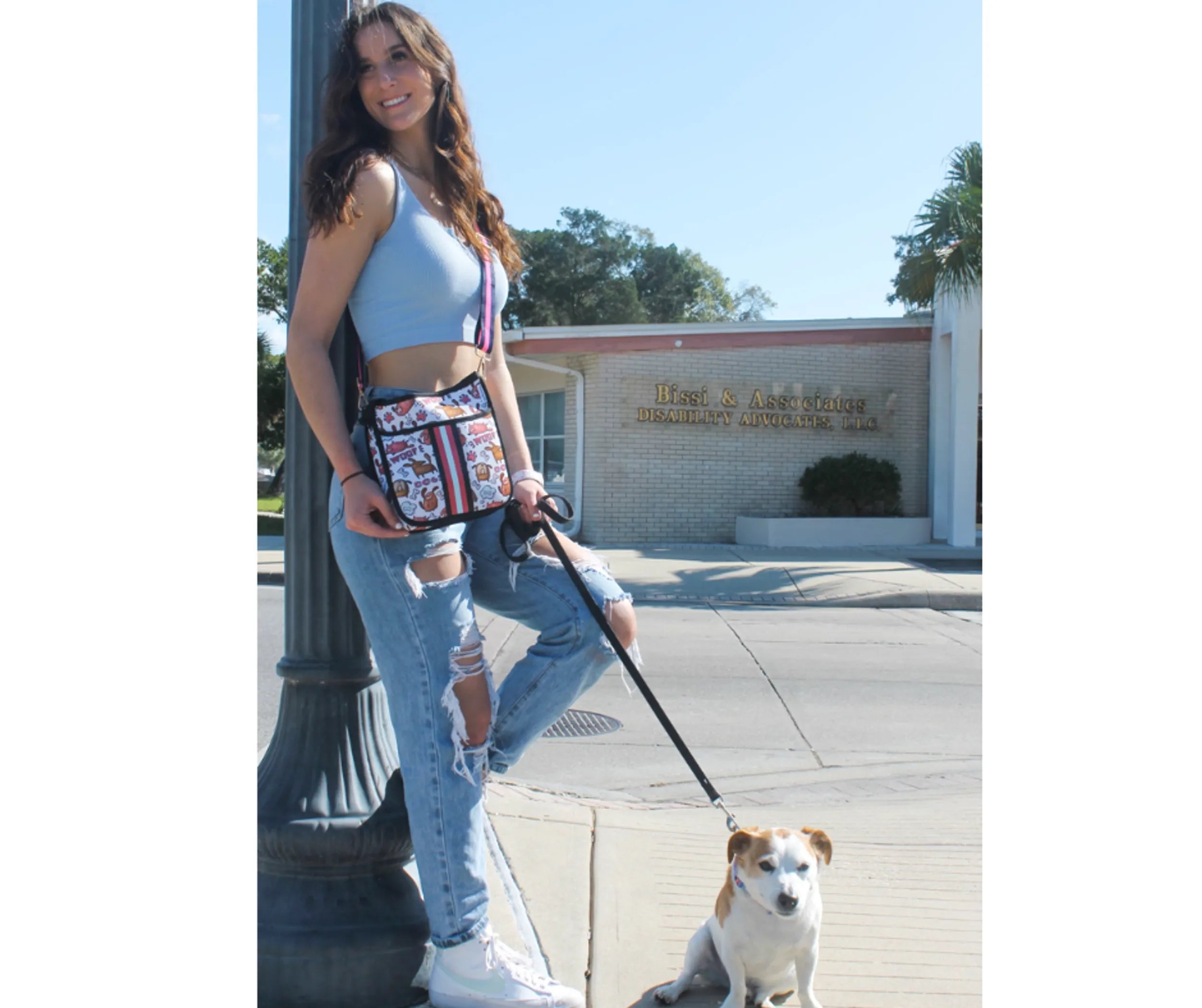 Woman walking a dog on a leash in an urban setting
