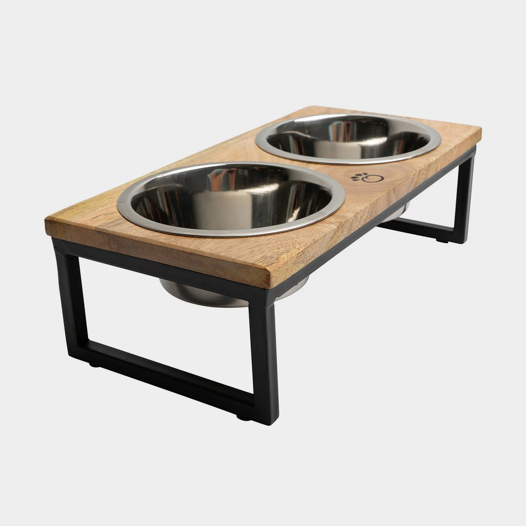 Wooden pet feeder with two stainless steel bowls on a white background