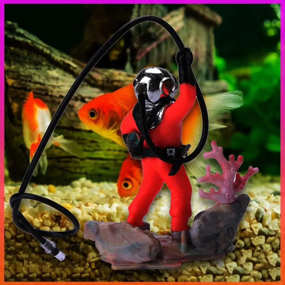 Fish tank decoration with a diver figure and goldfish.