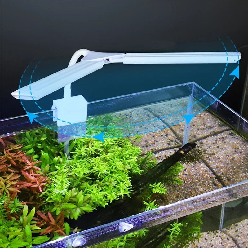 Aquarium with a light fixture above, showing water flow and plants.